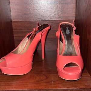 Open toe, strapped back faux leather coral pump. One pump has a scuff on it.